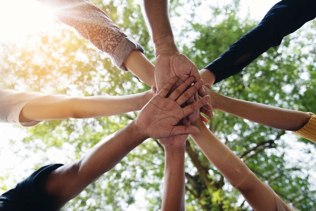 Hands joining together in a gesture of solidarity and teamwork